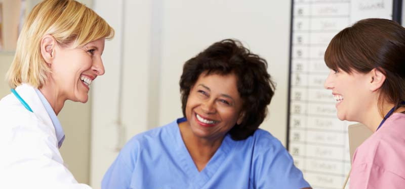 Nurses Talking and Smiling In a Hospital Setting